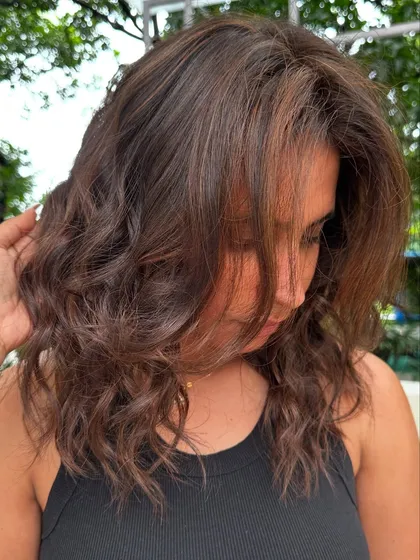 Holiday ready with these soft, beachy waves and subtle brunette highlights. This is a low-maintenance color that grows out beautifully, perfect for someone who travels a lot.