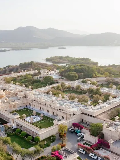 An aerial drone shot of The Leela Palace Udaipur, showcasing its stunning location on the banks of Lake Pichola. We help you select destination venues that offer not just a location, but a breathtaking experience.