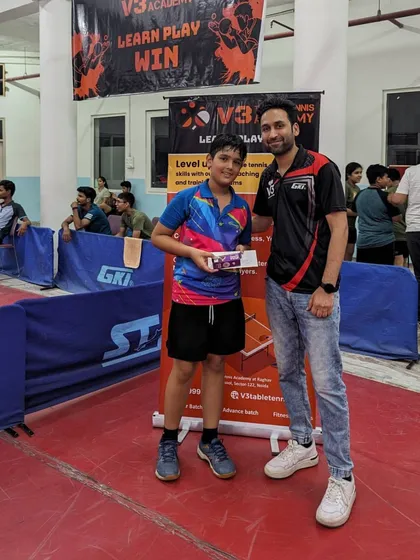 A participant from the 1st V3 Open Table Tennis Tournament receiving his prize. I handle all aspects of the event to ensure it runs smoothly for everyone involved.