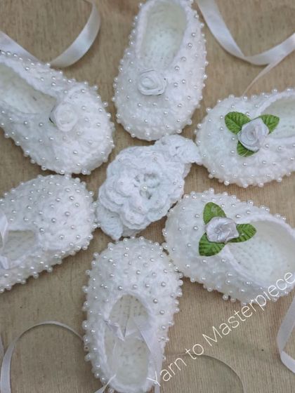 A beautiful assortment of my white baptism shoes, featuring different styles from pearl-studded to rose-adorned designs, ready for your baby's special day.