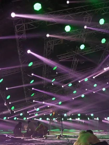 The stage floor during lighting programming for the 'Po Po' song, with beams of light crisscrossing the space.