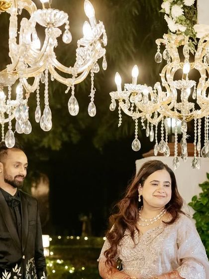 The couple enjoying a moment under the sparkling crystal chandeliers that lined their Sangeet entrance walkway.