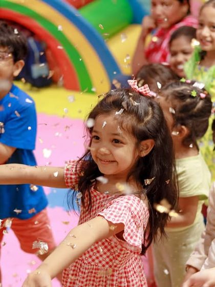 A shower of confetti rains down on the happy children. These moments of celebration are a key part of the fun at our parties.