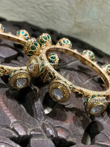 My Rajwadi polki and meenakari bangles are perfect for a bride. The combination of uncut diamonds and vibrant green enamel work on a textured gold base makes for a truly stunning and traditional accessory.