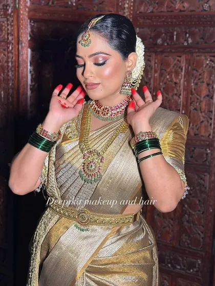 A classic South Indian bridal look is all about the details. Here, you can see the perfect balance of a shimmering gold Kanjeevaram saree, traditional temple jewelry, and makeup that enhances her features without overpowering them.