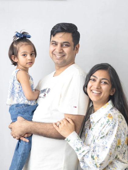 A classic family of three portrait. The simple white background and natural smiles make this a timeless and beautiful memory.