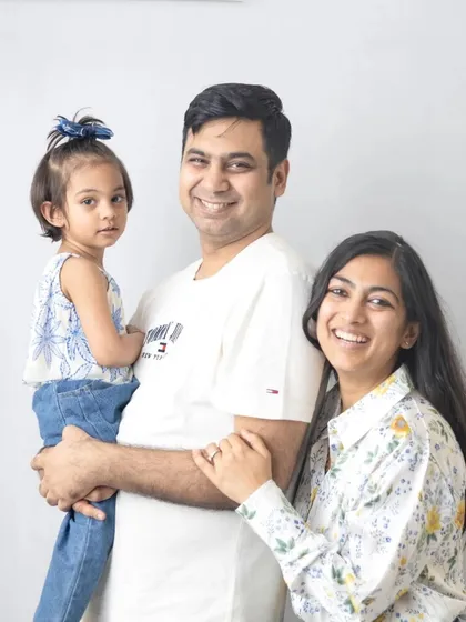 A classic family of three portrait. The simple white background and natural smiles make this a timeless and beautiful memory.