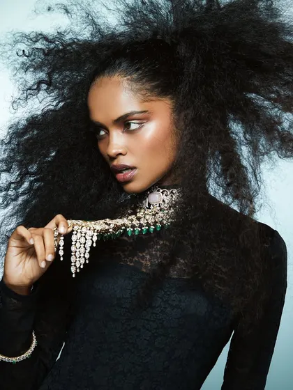 A full shot of the voluminous hair and sculpted glam look, showing how makeup and hair can work together to complement high-end jewelry and fashion.
