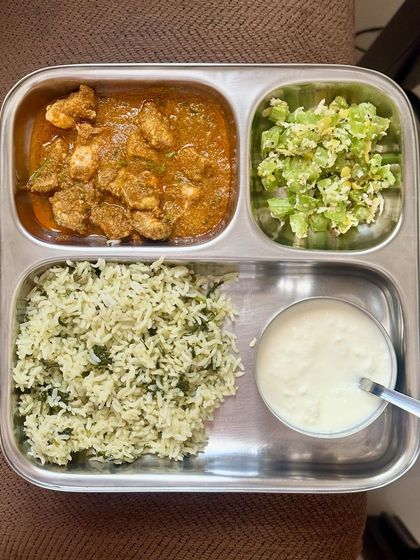 A balanced meal of dill-flavored rice, chicken curry, sautéed snake gourd, and curd.