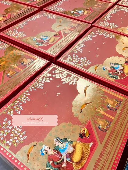 A top-down view of our red and gold wedding boxes, featuring beautiful artwork depicting a royal procession. These boxes are designed to be keepsakes.
