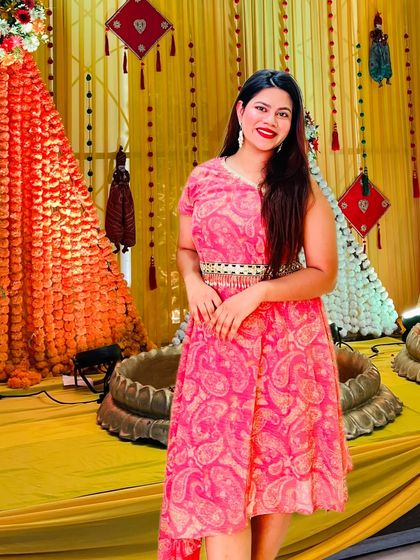 Rocking a pink dress against the traditional yellow Haldi decor. It's all about creating a fun, vibrant look.
