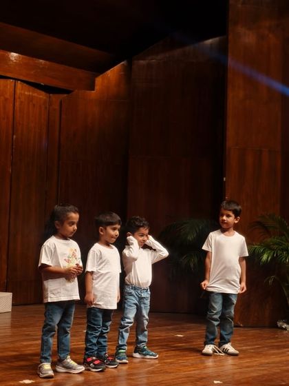 Four young boys performing together, learning to share the stage and support each other.