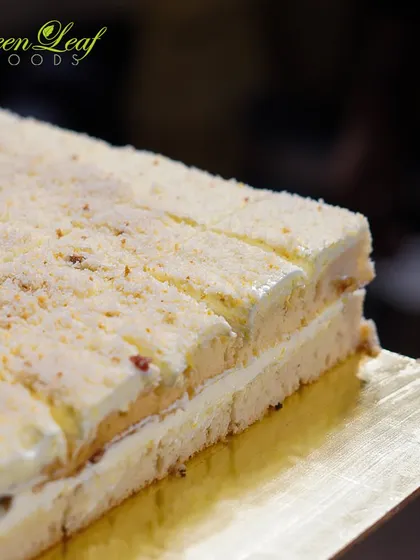 Kuch meetha ho jaye? A celebration is incomplete without dessert. This image shows a large, freshly made pastry, sliced and ready to be served, showcasing the quality and scale of our dessert offerings.