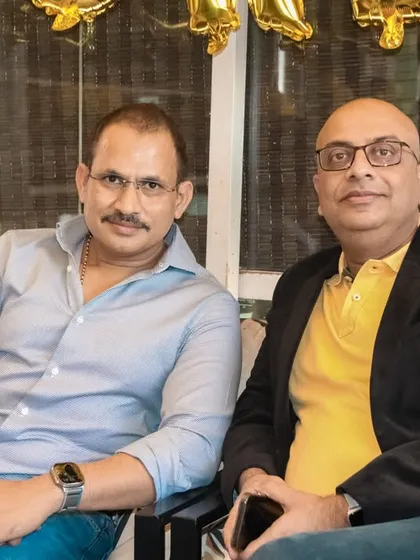Two colleagues or friends posing for a photo at a corporate get-together. I provide professional photography for social and business events.