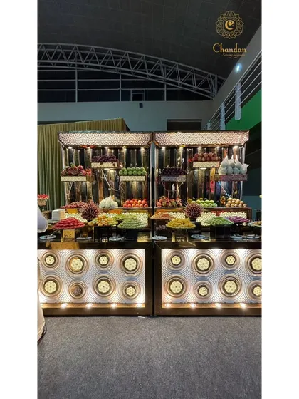 An elaborate and artistic fruit display counter. I turn simple fresh fruit into a visual masterpiece with creative arrangements and stylish stands.