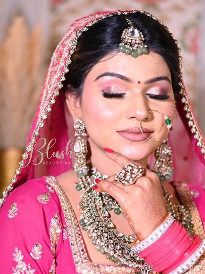 A beautiful pink-toned bridal look by a student. The soft glitter on the eyes and the glowing skin are signs of a well-executed makeup application.