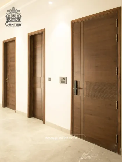 A door should complement the harmony of your home. Here you can see how my custom veneer doors integrate seamlessly into a modern residence, creating a clean, cohesive look throughout the hallway. Each door is designed to match the home's aesthetic.