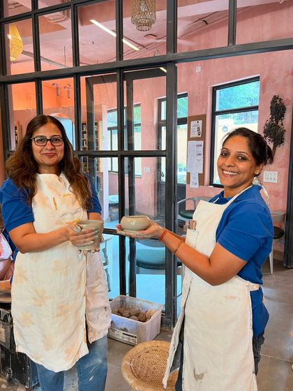 From lumps of clay to lovely bowls. Two happy students showing their creations at the end of a fun and productive taster session.