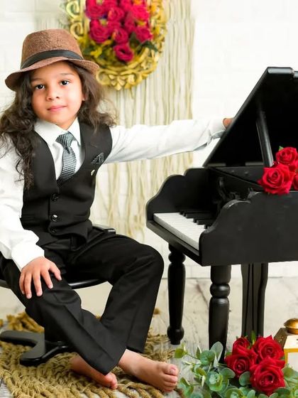 A dapper young man and his piano. This stylishly dressed boy looks so confident and charming in this classic, rustic photoshoot.
