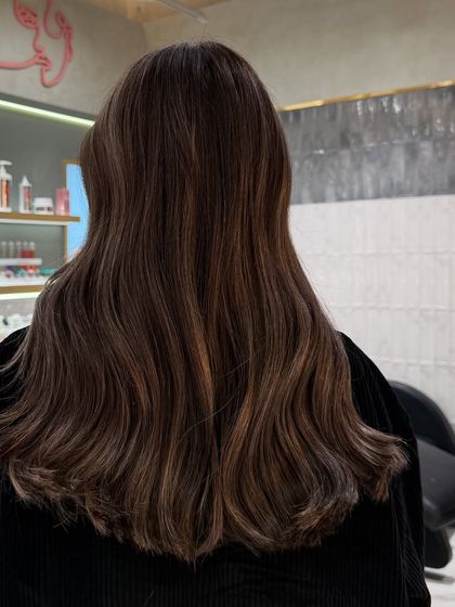 My signature balayage adds depth and movement to the hair. This back view shows how the highlights are woven through to create a seamless, natural-looking effect.