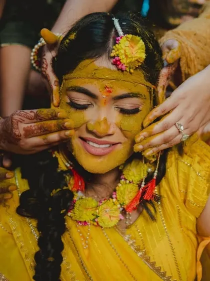 A bride's radiant smile during her Haldi ceremony. This pre-wedding ritual is full of color and emotion, and I make sure to capture its vibrant and playful spirit.