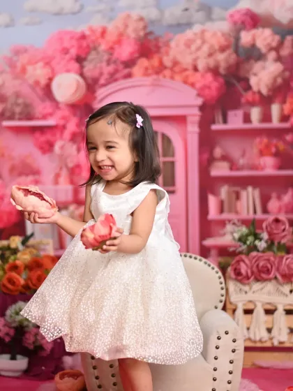This little girl is having fun in her pink wonderland. We create immersive sets that make your child feel like they are in a fairytale.