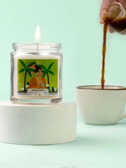 An action shot brings this coffee candle to life, with a stream of espresso being poured into a cup beside it. This dynamic visual connects the candle's scent directly to the experience of brewing fresh coffee.