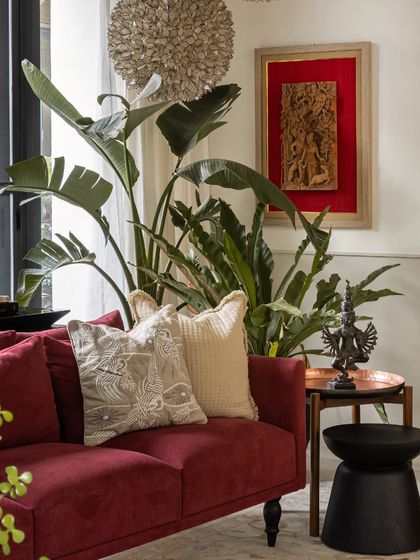 A close-up of the living area, showing how we layered textures and objects. The embroidered cushions, bronze sculpture, and framed antique textile create a rich, collected feel.
