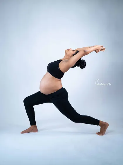 A strong and beautiful yoga pose captured in our studio. This shot celebrates the mother's strength and flexibility during pregnancy, creating an empowering and unique portrait.