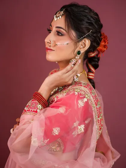 A side profile view that showcases the beautiful braided hairstyle adorned with flowers, a popular choice for lehenga looks.