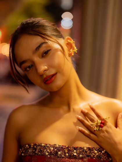 A close up of the jewelry and beauty look for Anushka's Cannes after party outfit. The intricate gold ear cuff and ring add a touch of modern edge to the traditional fabric.