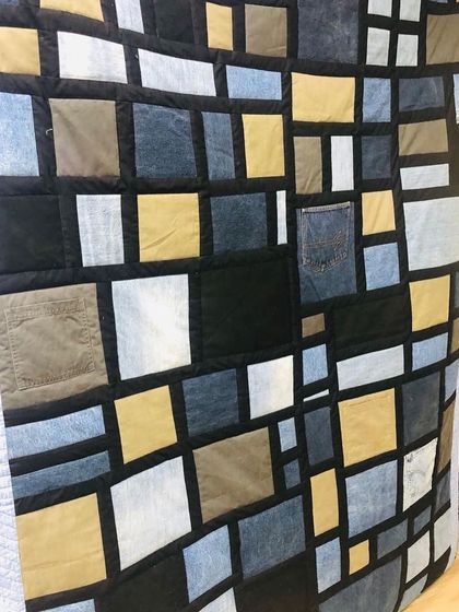A detail shot of the denim memory quilt, where you can even see a preserved jeans pocket incorporated into the design.