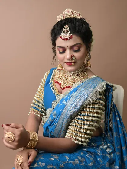 A seated pose that captures the royal essence of the look created by the student.