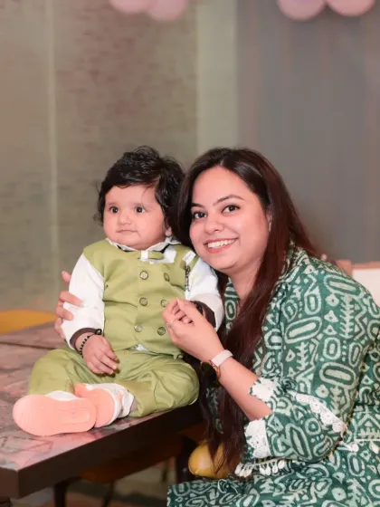 A mother and her baby boy enjoying the party atmosphere.