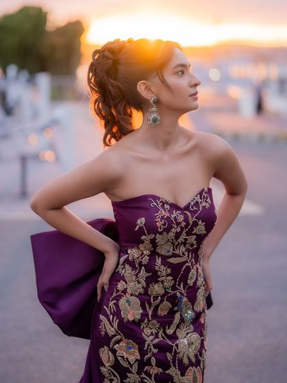The sunset light hitting the purple gown just right. These are the magical moments we aim for in red carpet styling.