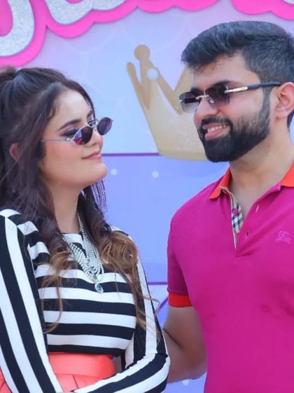 A candid shot of the parents enjoying their daughter's 3rd birthday party. While the focus is on the child, I always capture these moments of connection between the parents too.