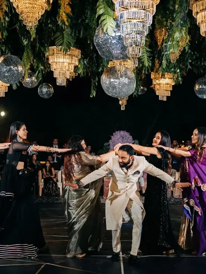 The groom surrounded by the bride's squad for a fun dance sequence. We love mixing and matching groups to create a dynamic and entertaining sangeet night.