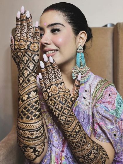 A happy client ready for Rakhi celebrations. Her full-hand jaal (net) pattern is a classic choice that always looks elegant and festive.