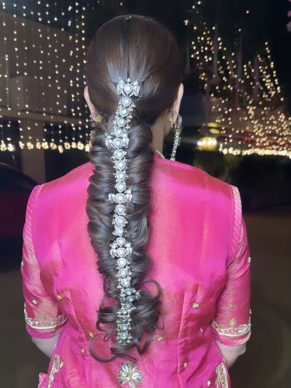 A close-up of this incredibly intricate and beautiful braid, adorned with a stunning silver hair accessory for a royal touch.