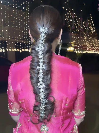 A close-up of this incredibly intricate and beautiful braid, adorned with a stunning silver hair accessory for a royal touch.