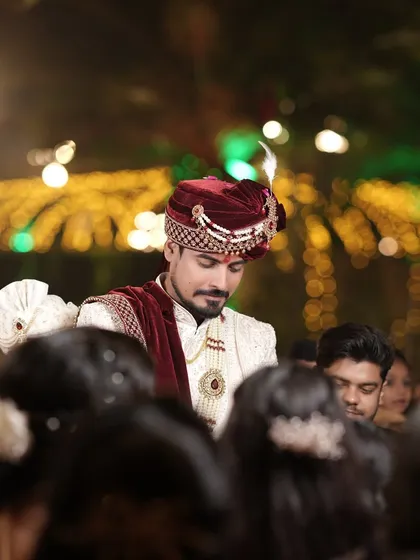 A candid shot of the groom amidst the crowd, his expression a mix of excitement and emotion.