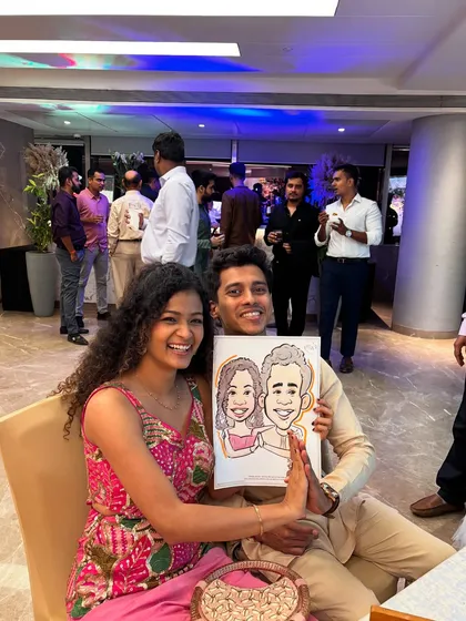 The smiles say it all. This couple enjoyed getting their portrait drawn live during an evening celebration, adding a touch of interactive fun for them and their guests.