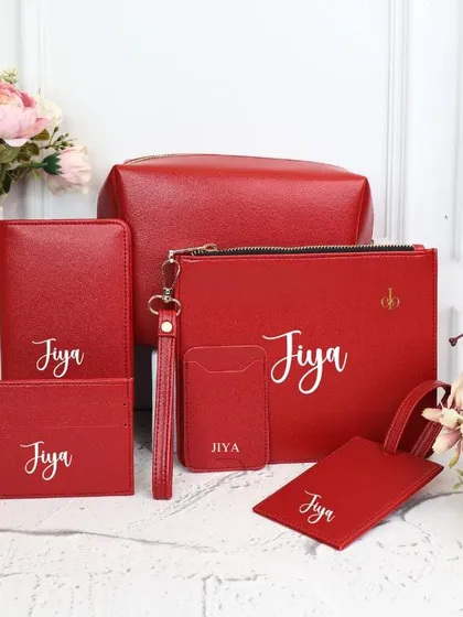 Our personalized travel combo set in a vibrant red. All six pieces are customized with the name "Jiya."