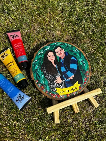 The finished couple portrait, photographed outdoors to show how the colors pop in natural light. The green leafy background makes the figures stand out beautifully.