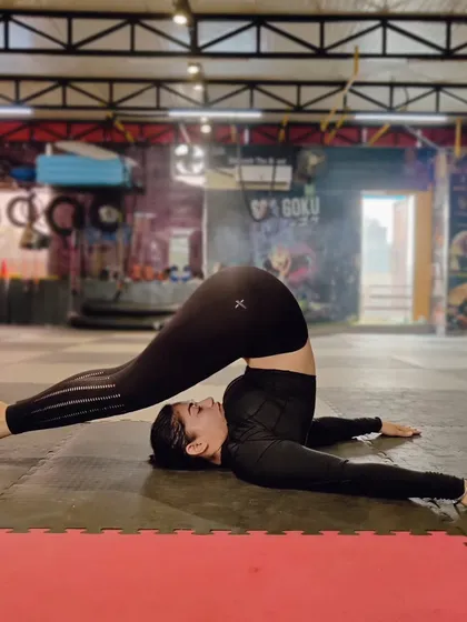 The plow pose (Halasana) provides a deep stretch for the back and shoulders. It's a key part of our mobility work to counteract the effects of intense training.
