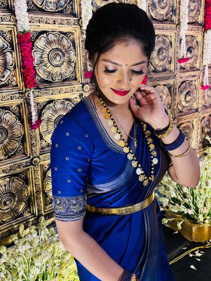 A portrait of the client in her royal blue ensemble, accessorized with a traditional coin necklace (kasina sara).