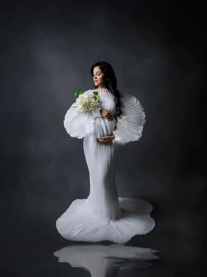 A portrait of strength, grace, and anticipation. In the studio, we use dramatic lighting and elegant gowns from my collection to create timeless images that celebrate your journey to motherhood.