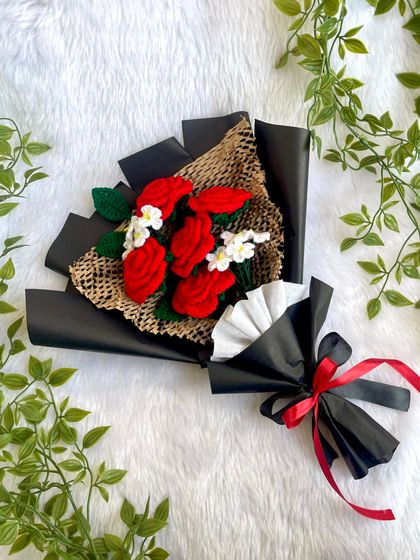 A full shot of the red rose bouquet in its black wrapping, tied with a red and black ribbon. This design is popular for its bold and romantic look.