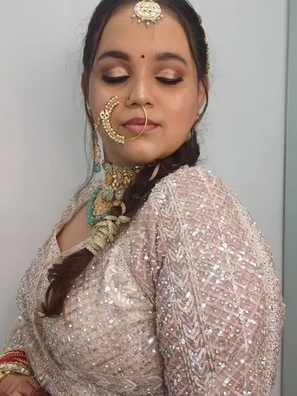 A portrait of a bride wearing our pastel lehenga and mint green jewellery, showing how well they pair together for a soft, modern bridal look.