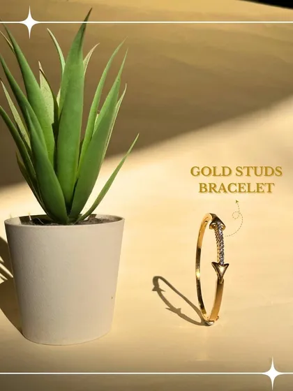 This modern gold studs bracelet adds a directional, contemporary edge to your wrist. It is a piece that speaks of confidence and unique style.